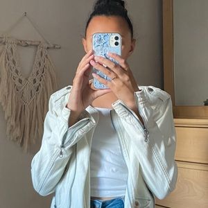 A leather jacket styled white washed denim jacket with metal details